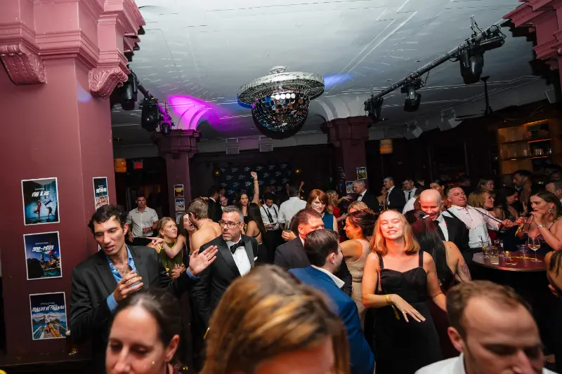 A packed room under the disco ball