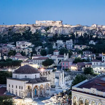 The Acropolis above the rooftops of Athens at dusk on the SYB Greece trip