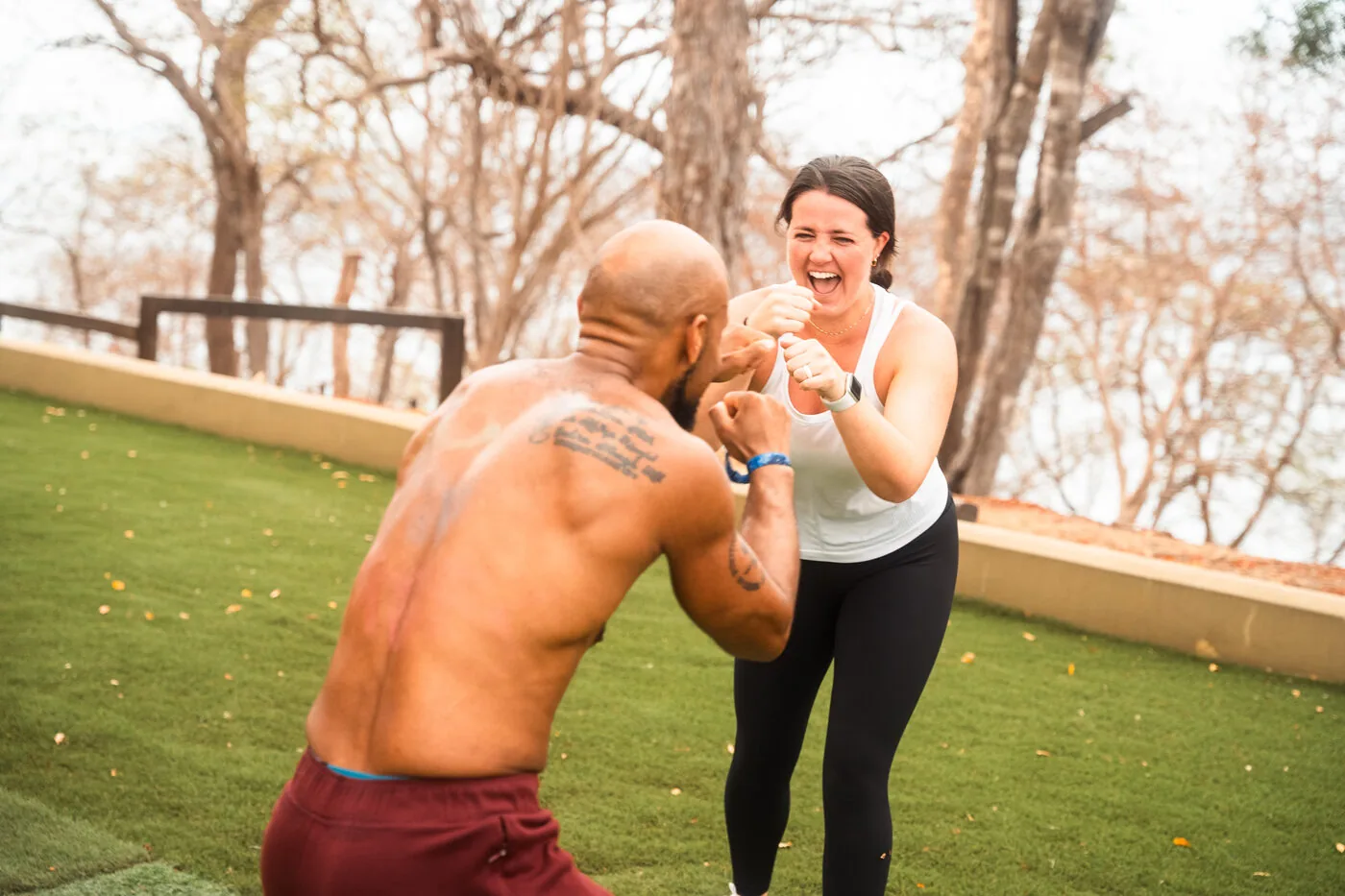 Two travelers doing a boxing drill on the lawn at the villas in Nicaragua