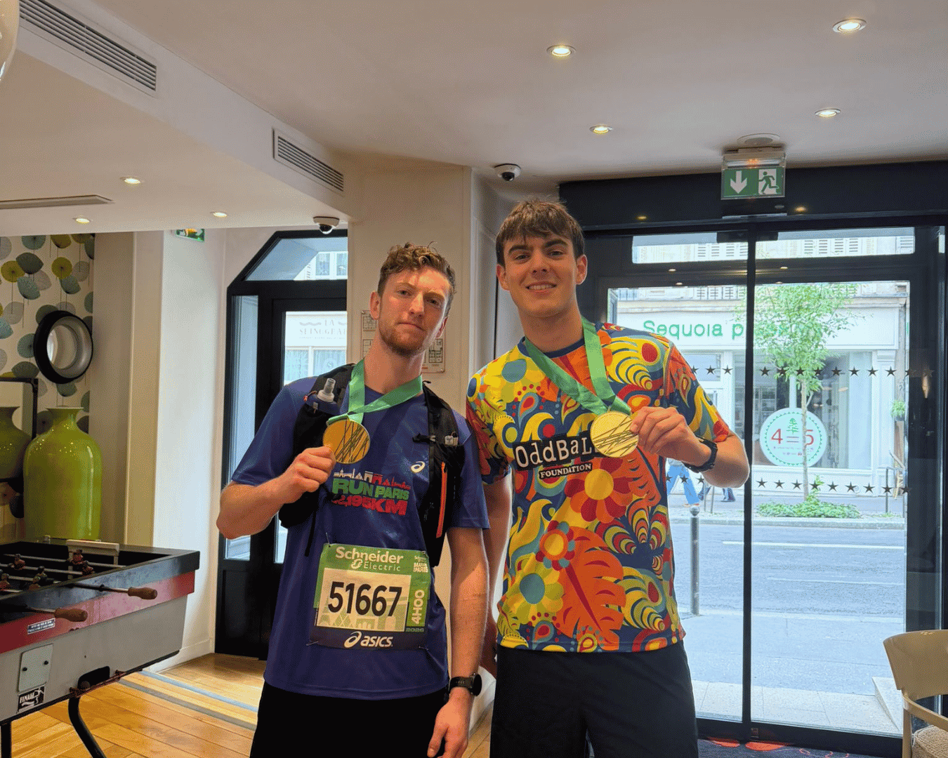 Two race finishers of the Athens marathon celebrating with the rest of the Hardest Adventures crew with their Athens marathon medals.