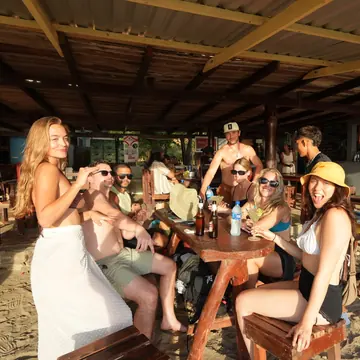 SYB crew around the tables at a beach bar on the SYB Nicaragua trip