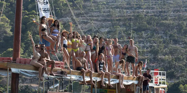 The crew lined up along the side of the wooden ship on the SYB Croatia trip