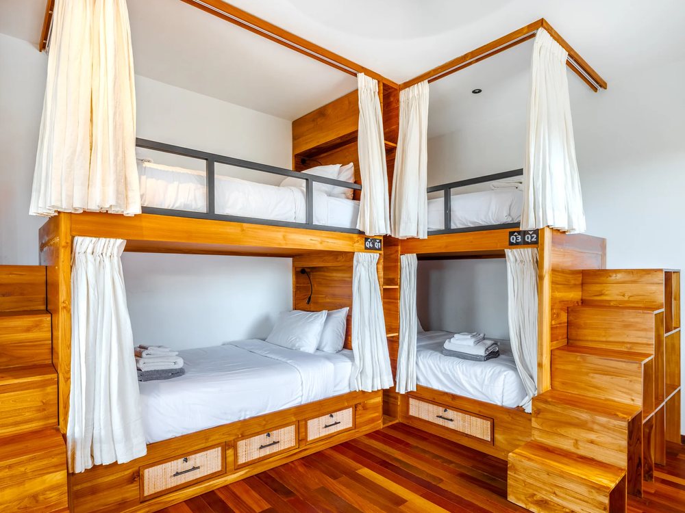 A shared room with its own curtained beds