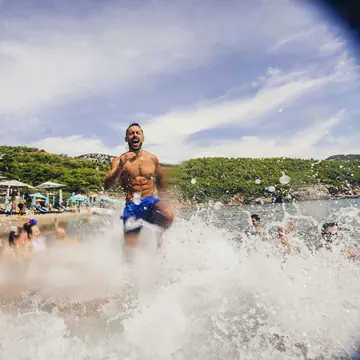 Running through the shallows with a big splash at the beach on the SYB Croatia trip