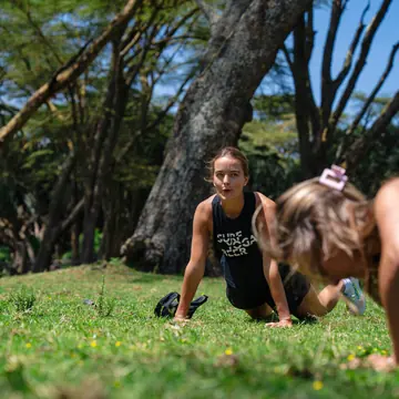 Push ups on the lawn under the trees on the SYB Kenya trip