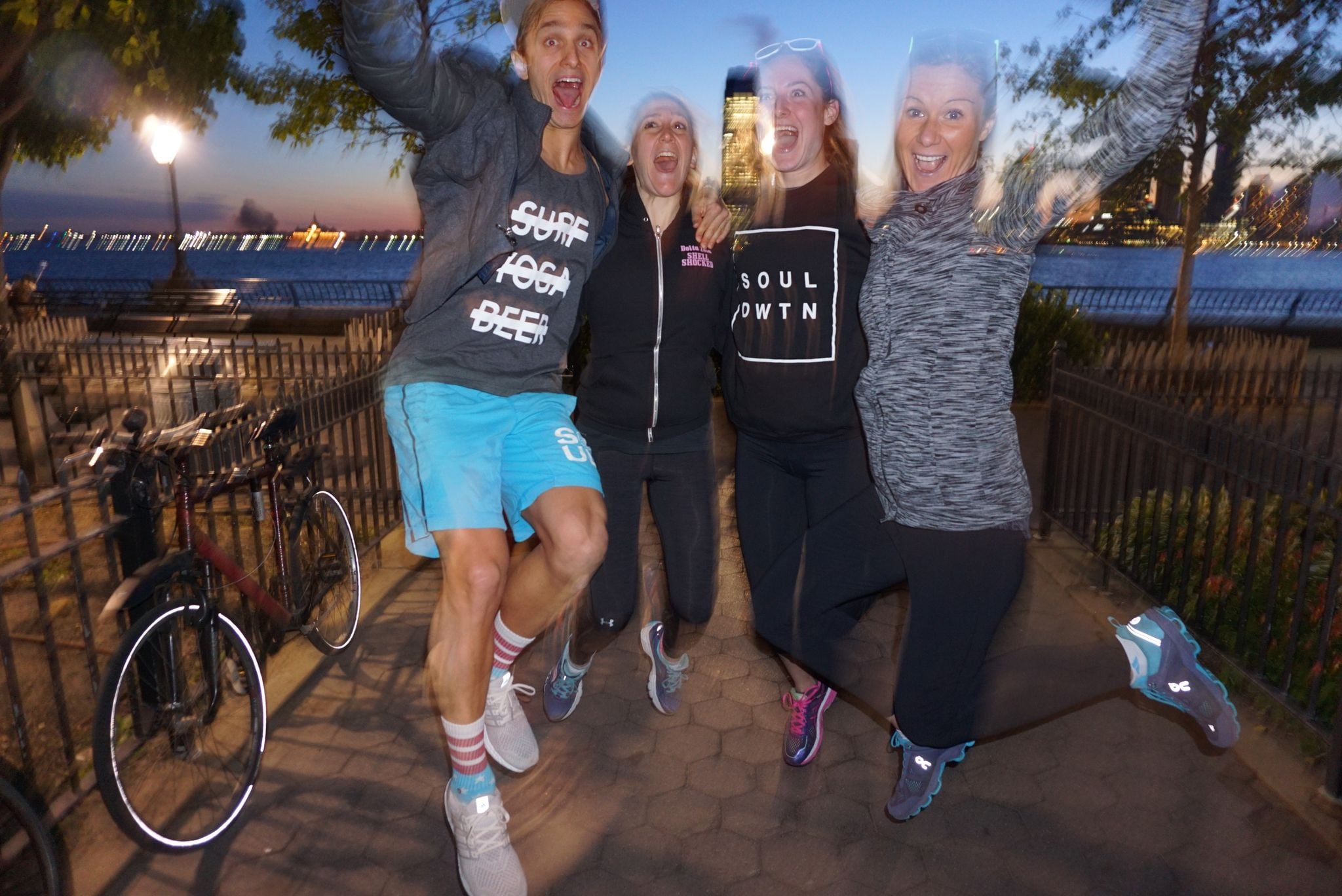 Run club jumping at night on the waterfront