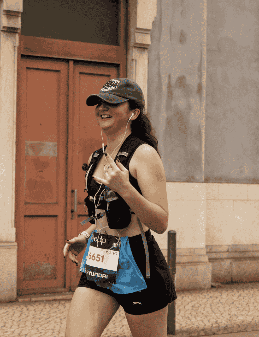 Hardest Adventures participant smiling whilst running the Paris Marathon for charity.