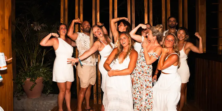 Friends in white flexing and posing at the white party on the SYB Nicaragua trip