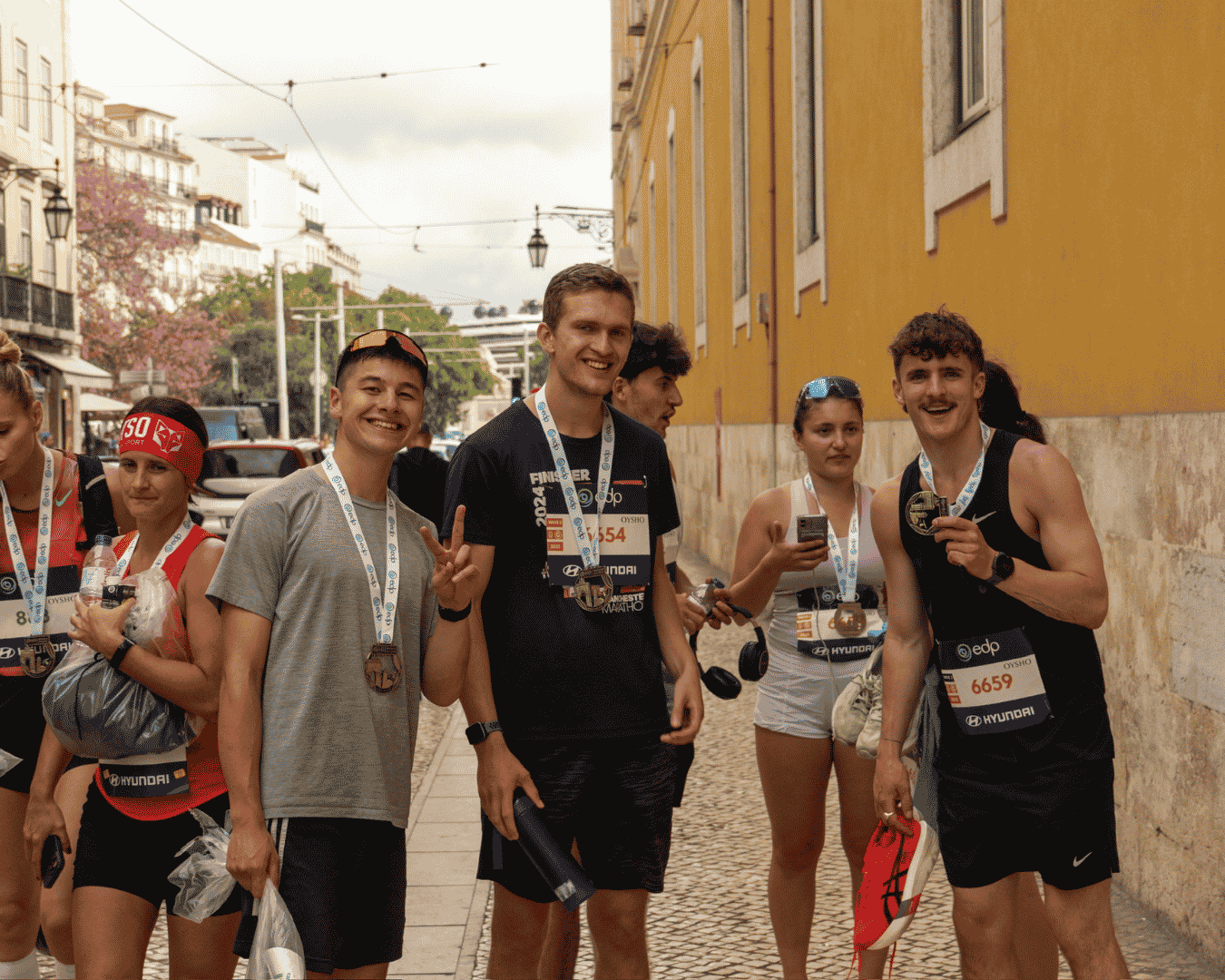 Group of Hardest Adventures runners celebrating and laughing having just finished the Athens marathon.
