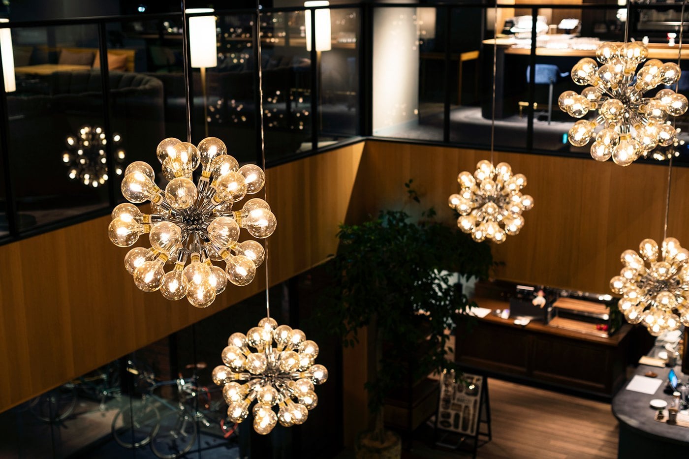 The lit atrium and staircase inside THE KNOT TOKYO Shinjuku