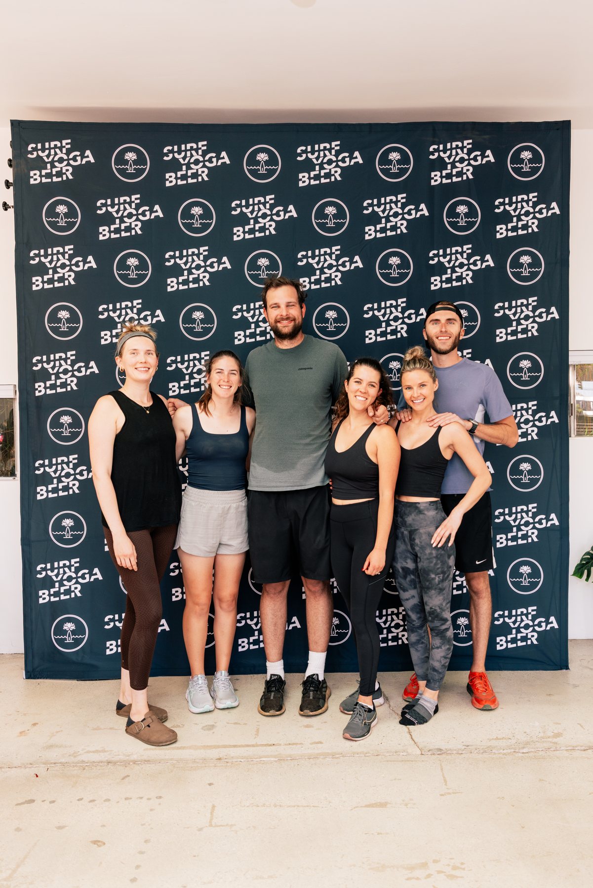 The crew lined up at the backdrop
