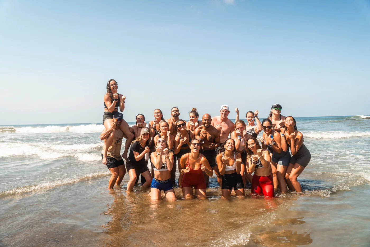An SYB group standing together in the shallows at Playa Maderas, Nicaragua