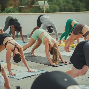 Downward dog during a rooftop yoga class on the SYB Amalfi Coast trip