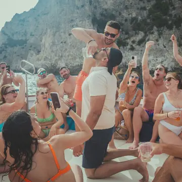 Boat party under the cliffs with the whole crew cheering on the SYB Amalfi Coast trip