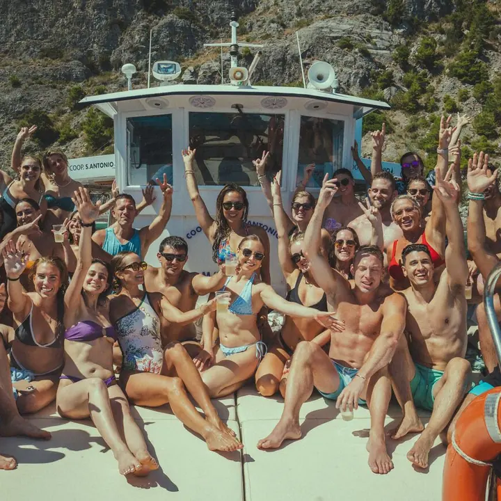 The whole crew cheering on the bow of the boat on the SYB Amalfi Coast trip