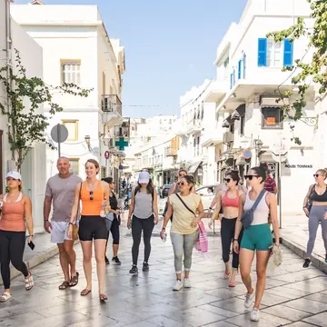 The crew walking down a whitewashed island street on the SYB Greece trip