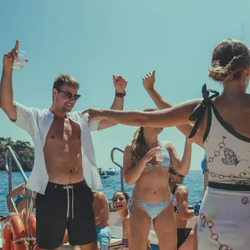 Dancing on the deck of the boat on the SYB Amalfi Coast trip
