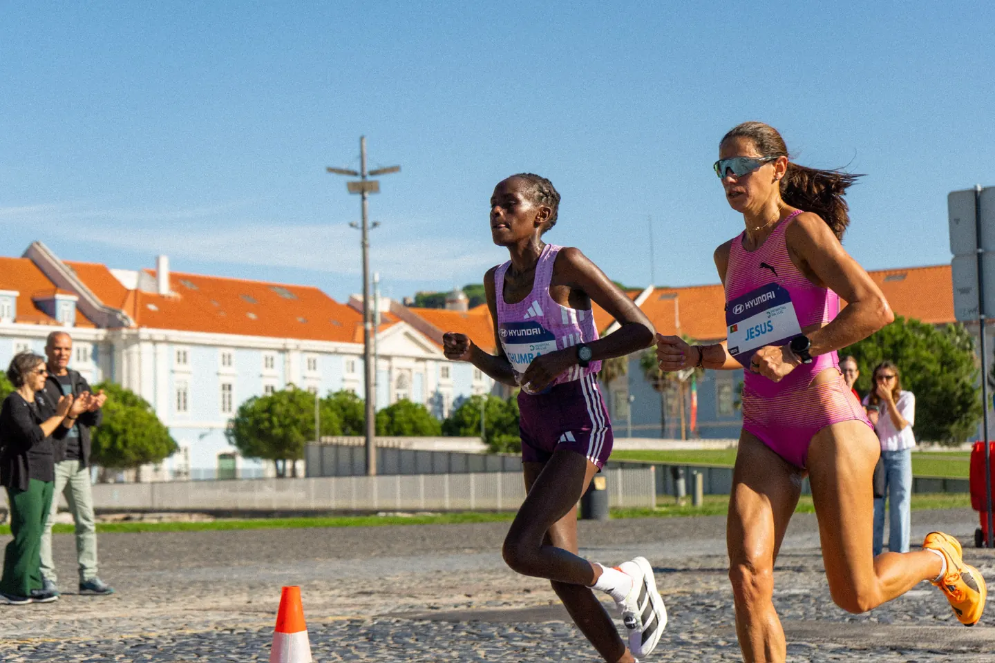 Two elite runners racing head to head at the Lisbon Marathon.