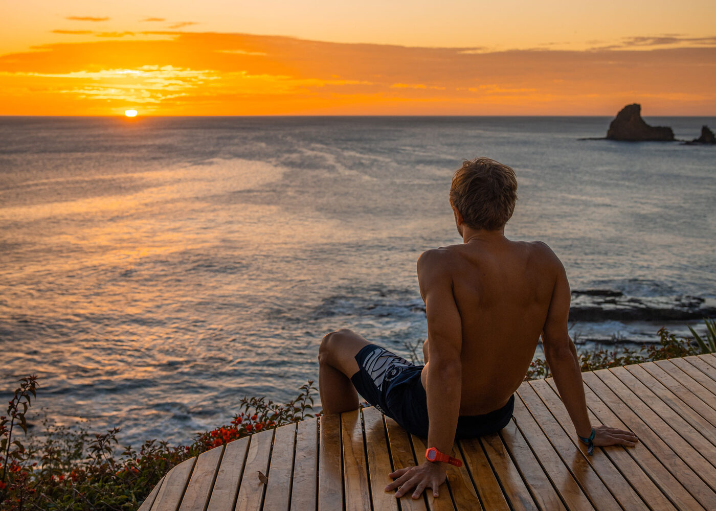 Watching the sun set over the Pacific from a deck above Playa Maderas