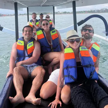 Friends in life jackets packed into a small boat on the SYB Bali trip