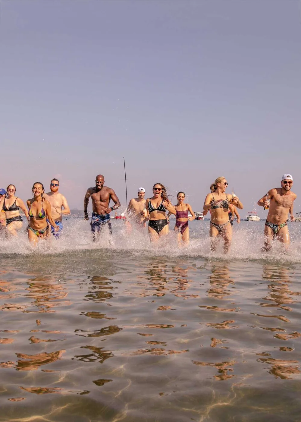 A group running through the shallows in hazy evening light on the SYB Croatia trip