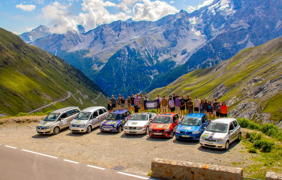Convoy of Hardest Adventures cars driving through an alpine mountain pass on the Dash to Dubrovnik road rally.