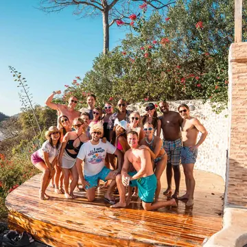 Crew photo on a wooden deck above the coastline on the SYB Nicaragua Surf Camp trip