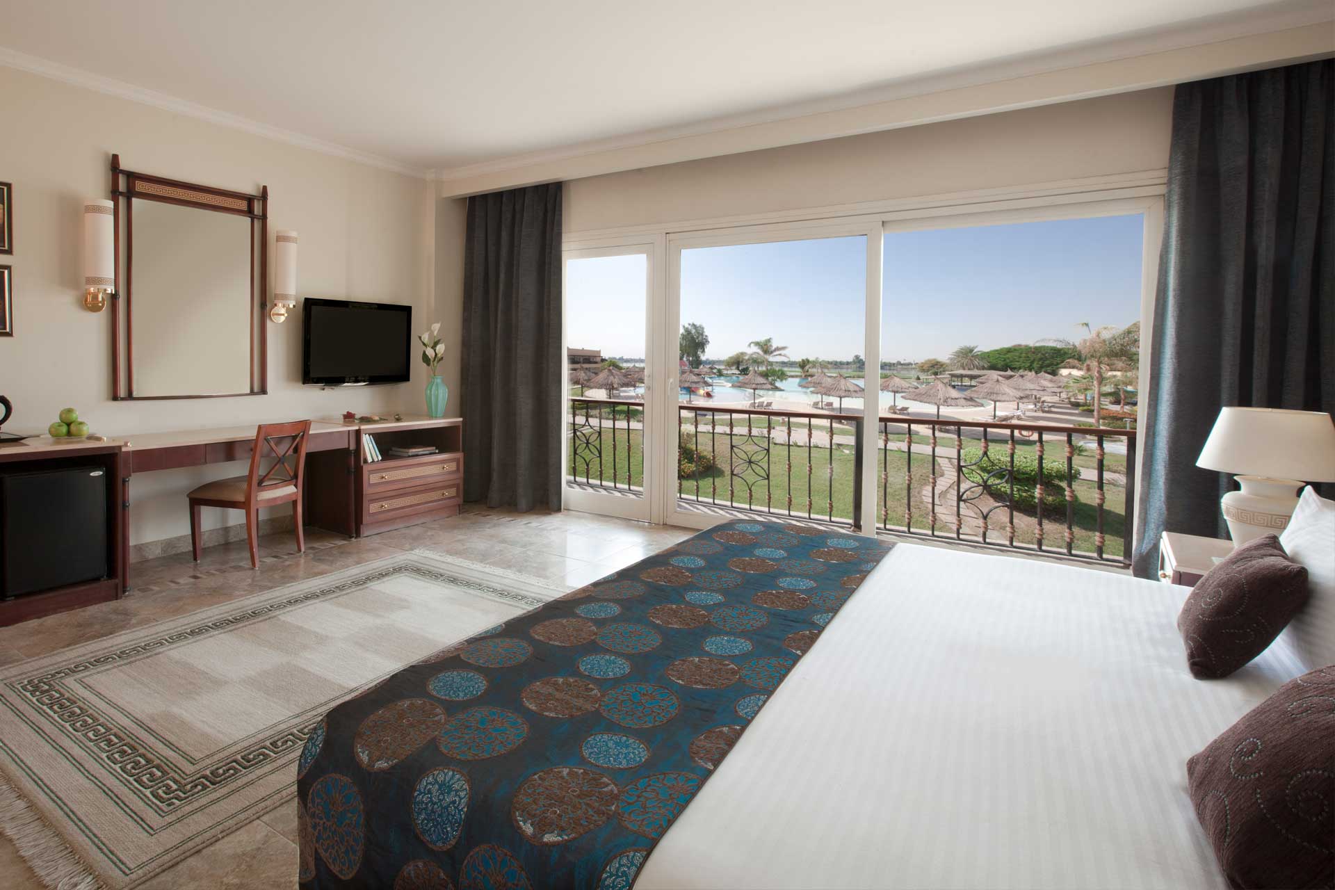 A Jolie Ville room with a balcony over the gardens and pool