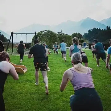 Morning lunges on the lawn during a group workout on the SYB Dolomites trip