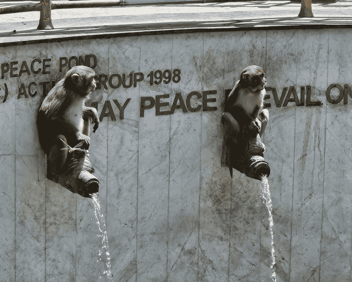 Monkeys sitting on pipes in the Monkey Temple of Kathmandu, Nepal.