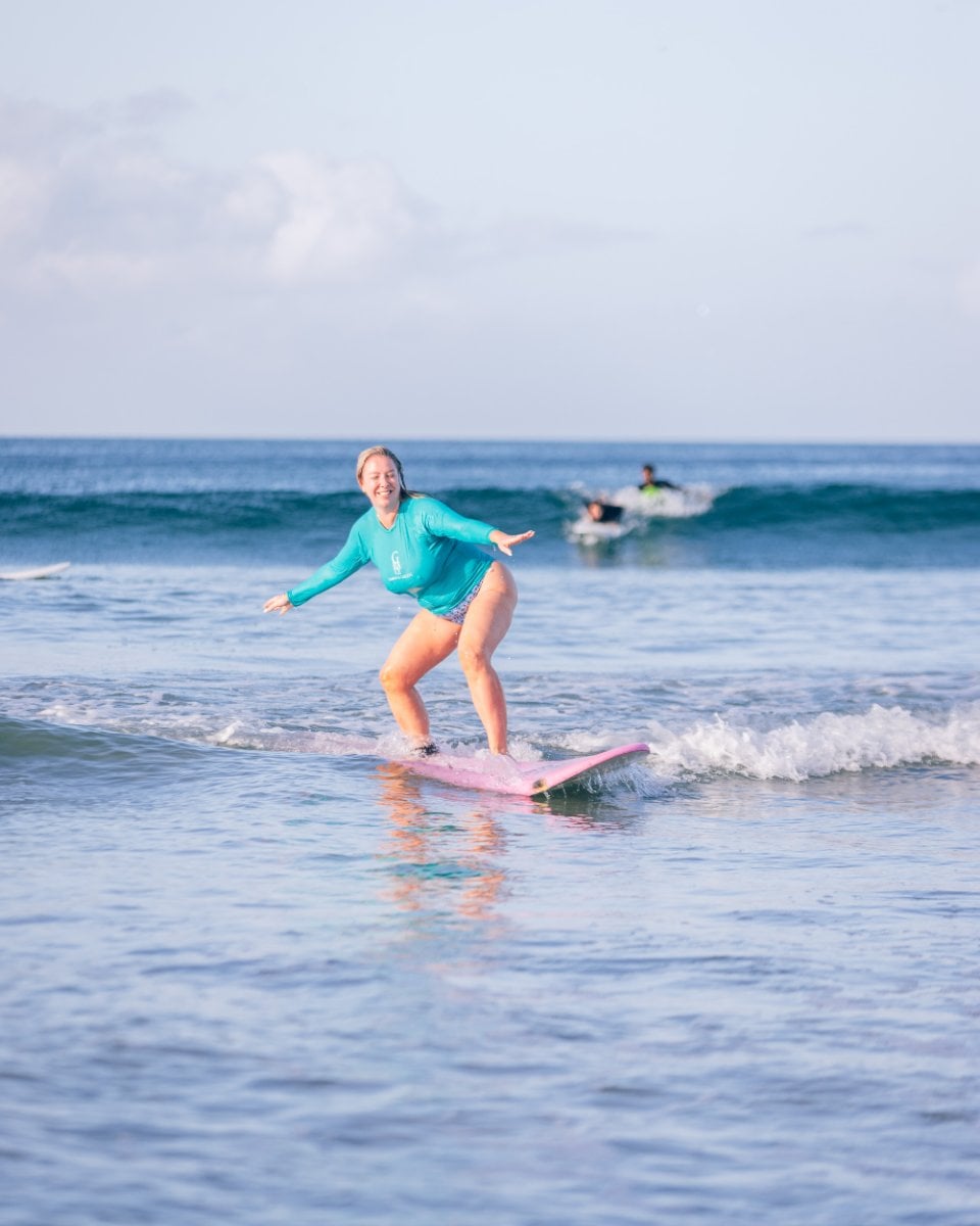 SurfYogaBeer guest riding a wave at Playa Maderas, Nicaragua