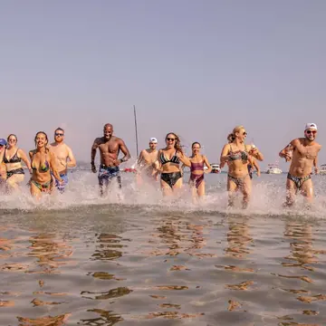 Group running through the shallows in hazy evening light on the SYB Croatia trip