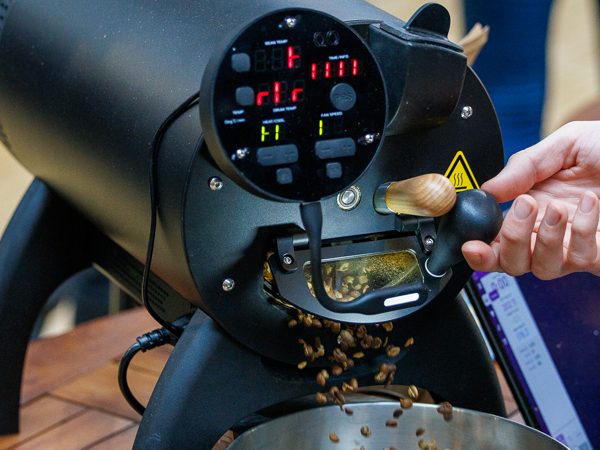 Freshly roasted beans pour from an Aillio Bullet roaster