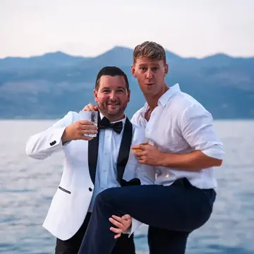 Two friends in formal wear goofing around by the water on the SYB Croatia trip