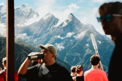 The group at the Namche acclimatisation viewpoint with Thamserku's summit clearing above the cloud
