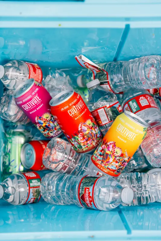A cooler of cold drinks and water on ice at the finish