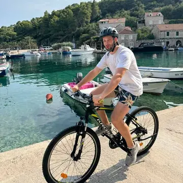 Riding a bike along a small harbour on the SYB Croatia trip