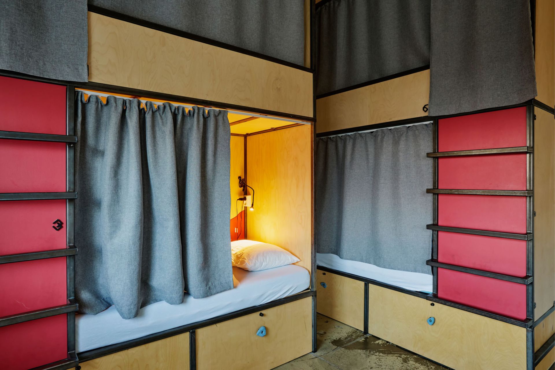 A shared room with a curtain on every bunk