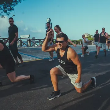 Group lunges during an outdoor morning workout on the SYB Amalfi Coast trip