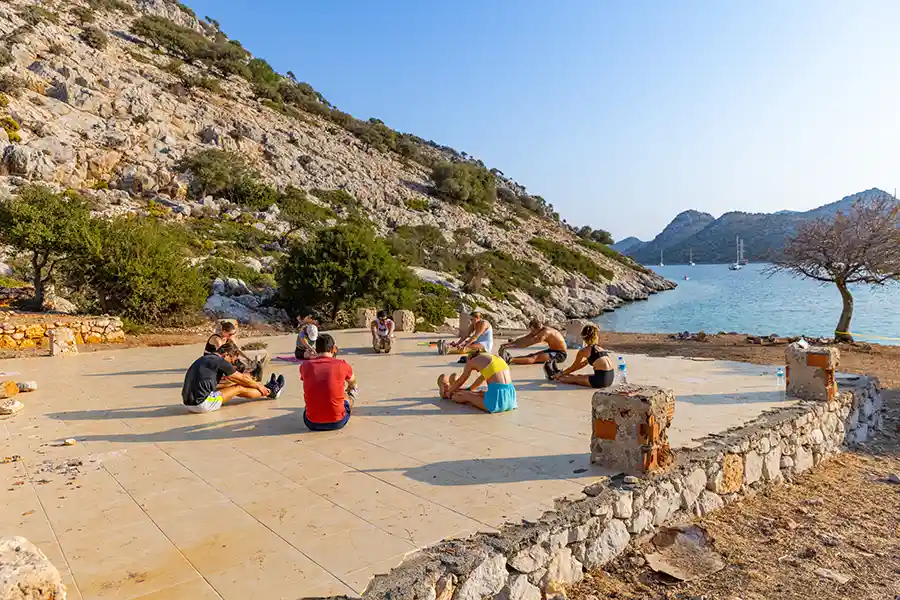 SurfYogaBeer group on a pebble beach on the Turkish coast