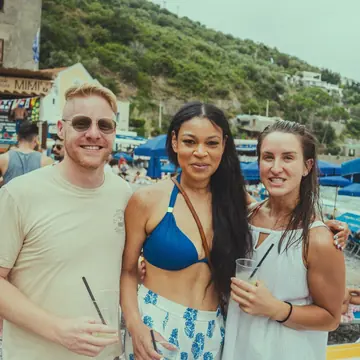 Three friends with drinks on the beach on the SYB Amalfi Coast trip