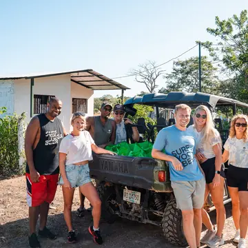 Group standing beside an open top buggy on the SYB Nicaragua Surf Camp trip