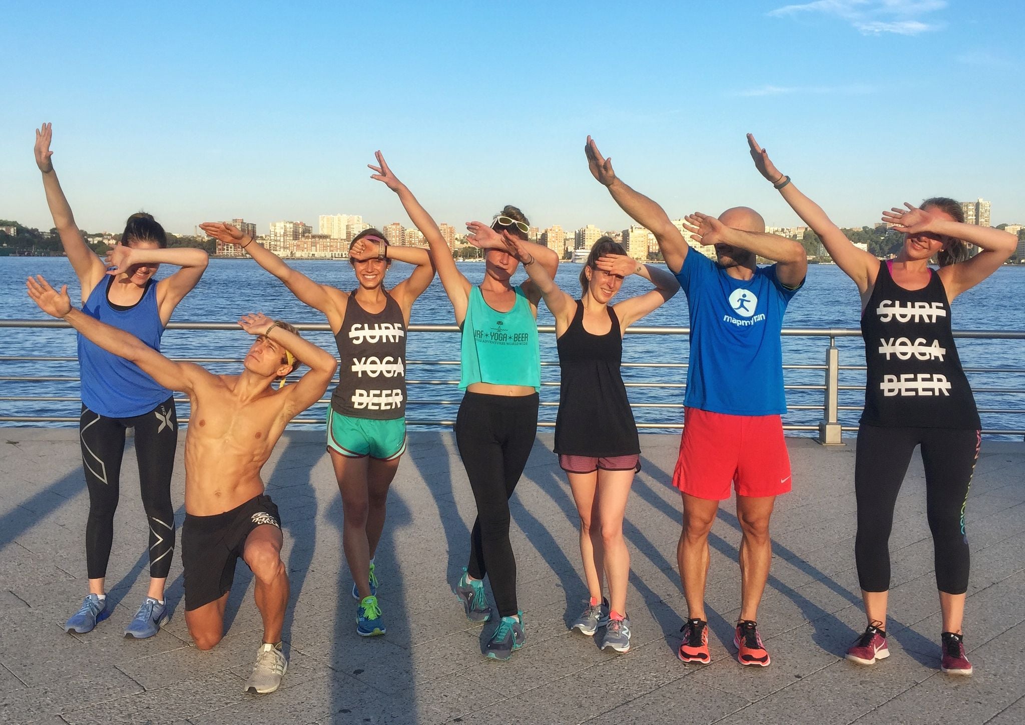 Run club members with arms up on the esplanade