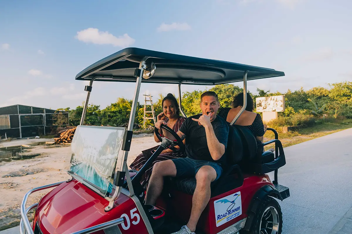 Golf cart convoy heading to Secret Beach in Belize