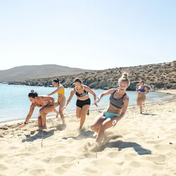 Relay race across the sand on a quiet beach on the SYB Greece trip