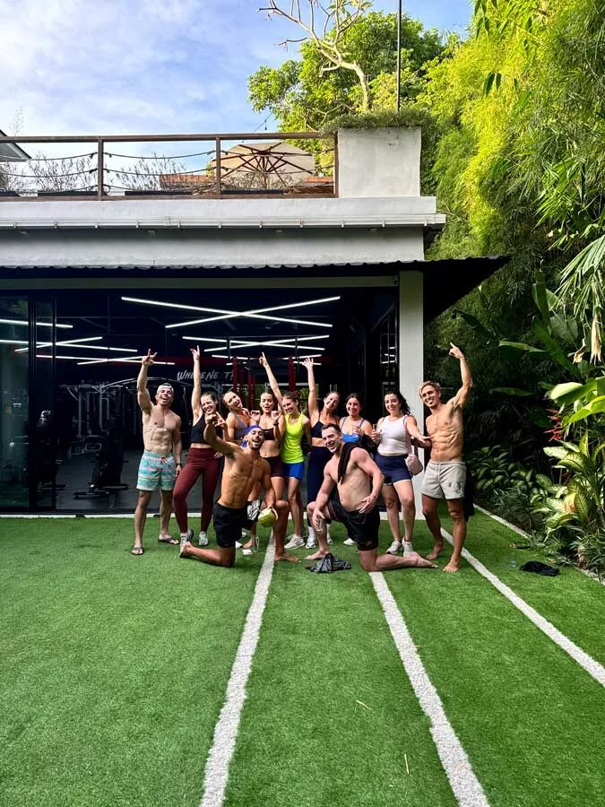 An SYB group posing on the turf outside the gym at the retreat in Canggu, Bali