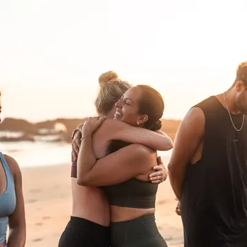 Two friends hugging on the beach at golden hour on the SYB Nicaragua trip