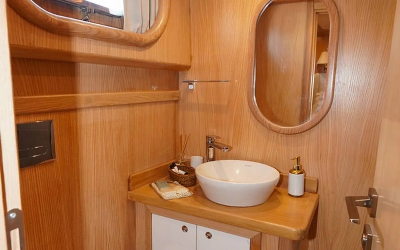 The private bathroom in a cabin, with a vessel sink and shower