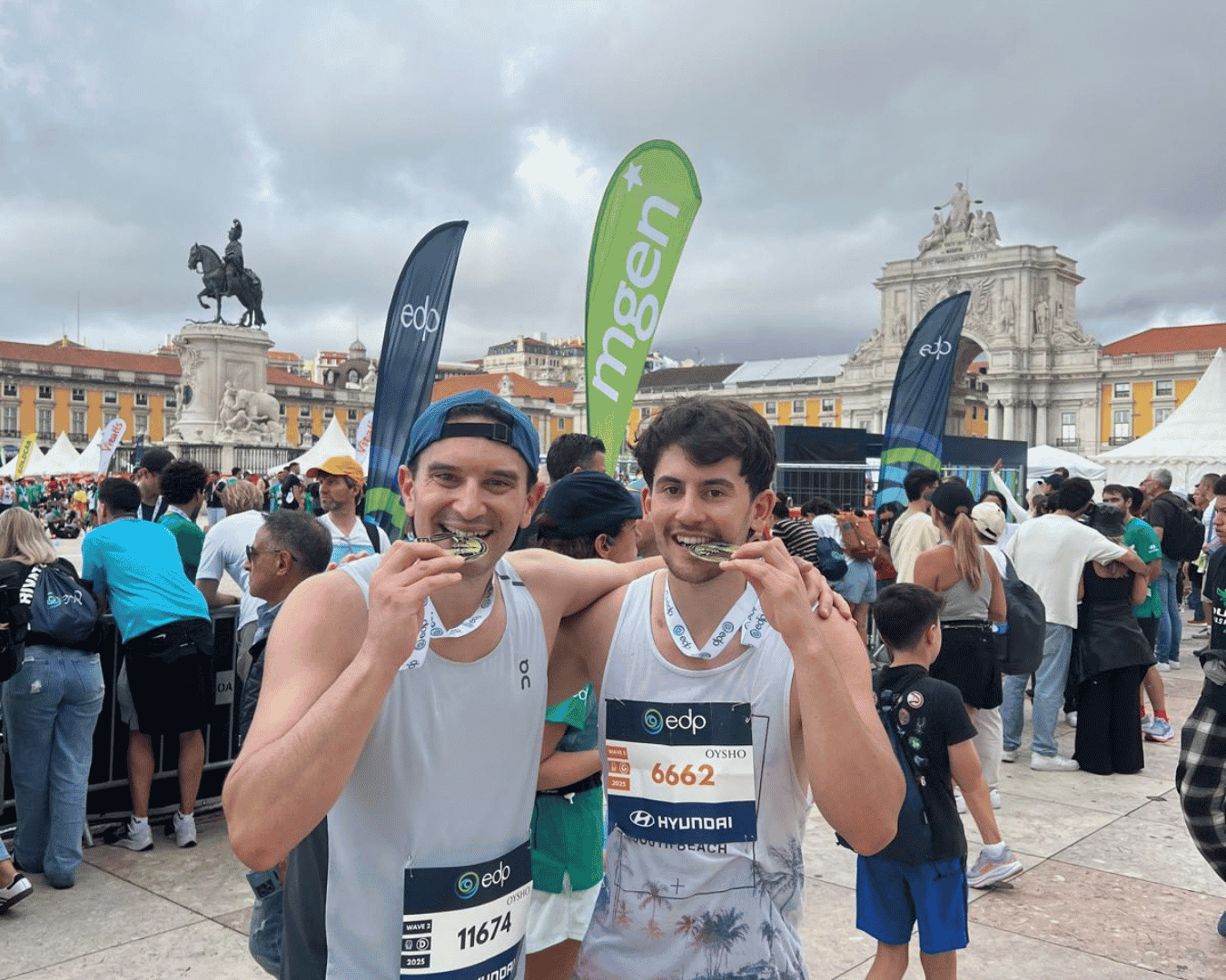 Two men shouting and cheering having just completed the Hardest Adventures Athens marathon with their medals around their neck.