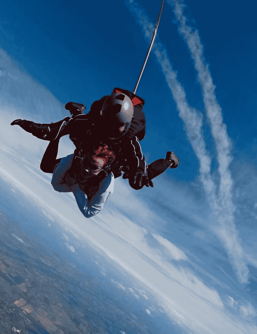 Female participant soaring through the air with tandem instructor as part of the Hardest Adventures charity skydive challenge.